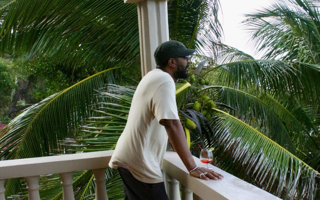 Guest relaxing on a verandah at Petite Anse Hotel on Grenada's north coast