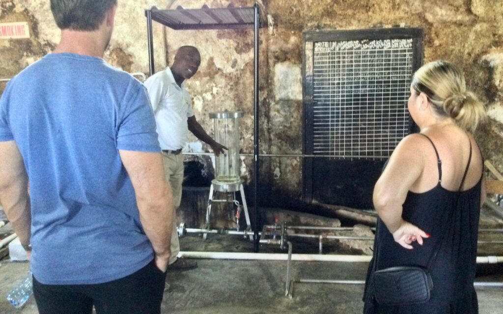 Guide explaining the rum-making process at River Antoine Rum Distillery