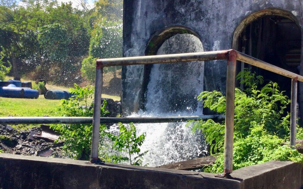 Water flowing from the historic water wheel at River Antoine Rum Distillery